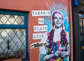 Street art of Dorothy saying there's no place like Brighton. Credit Harrison and Bamford. 