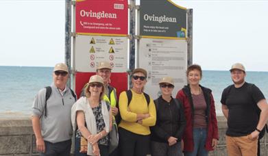 Walker in from of Ovingdean information board