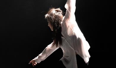 Person in casual wear dancing onstage