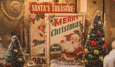 Books with Santa on the front and two tiny Christmas trees
