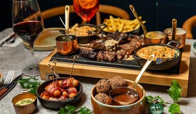 Dishes of delicious steak and sides at Kindling in Brighton