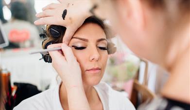Eyeliner expertly being applied to a model's eyes