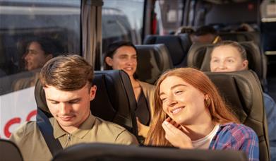 Happy travellers on a National Express coach.