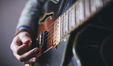 Person playing a guitar