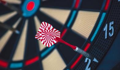 Red and white dart on dartboard