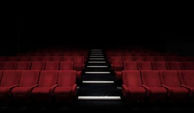 Empty red seats in a theatre