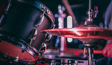 Black acoustic drum set with shiny hi hat