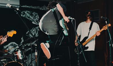Guitarist jumping on stage