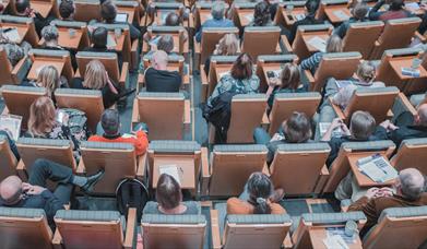 Individuals in busy conference