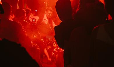 Dancers in orange lit night club