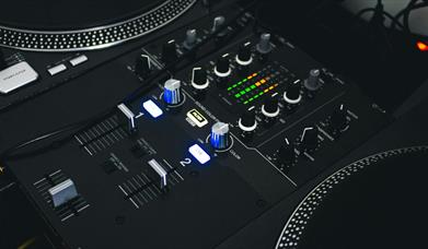 Black mixing desk with silver accents