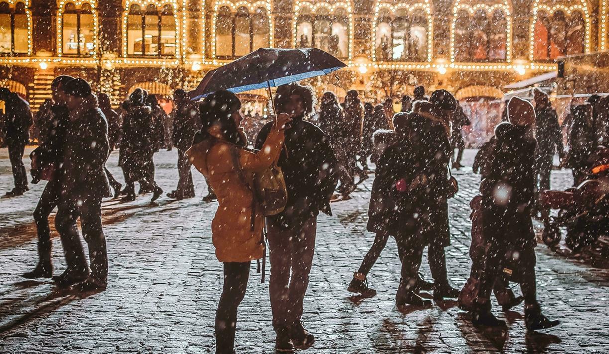 Busy and snowy cobbled street