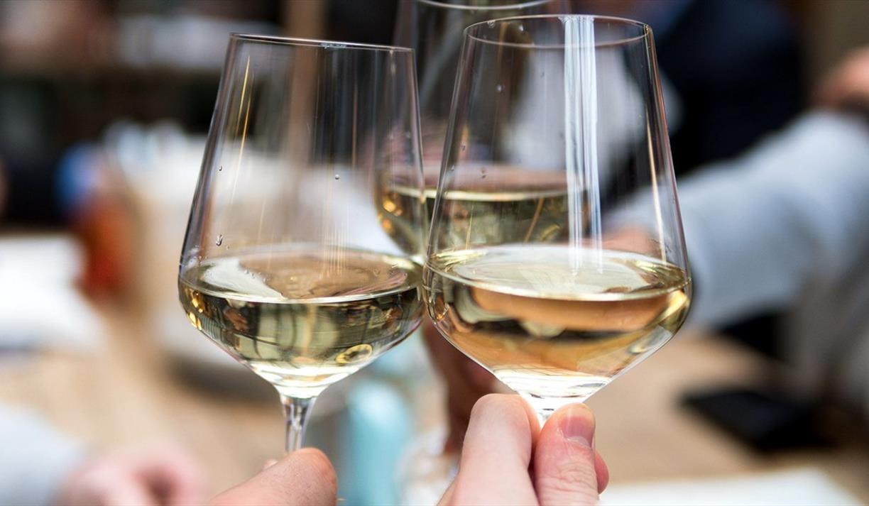 Three glasses filled with white wine