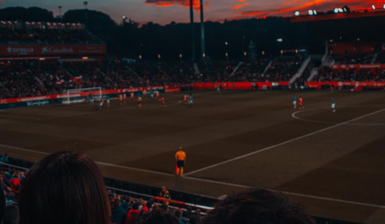 Football game at sunset in stadium