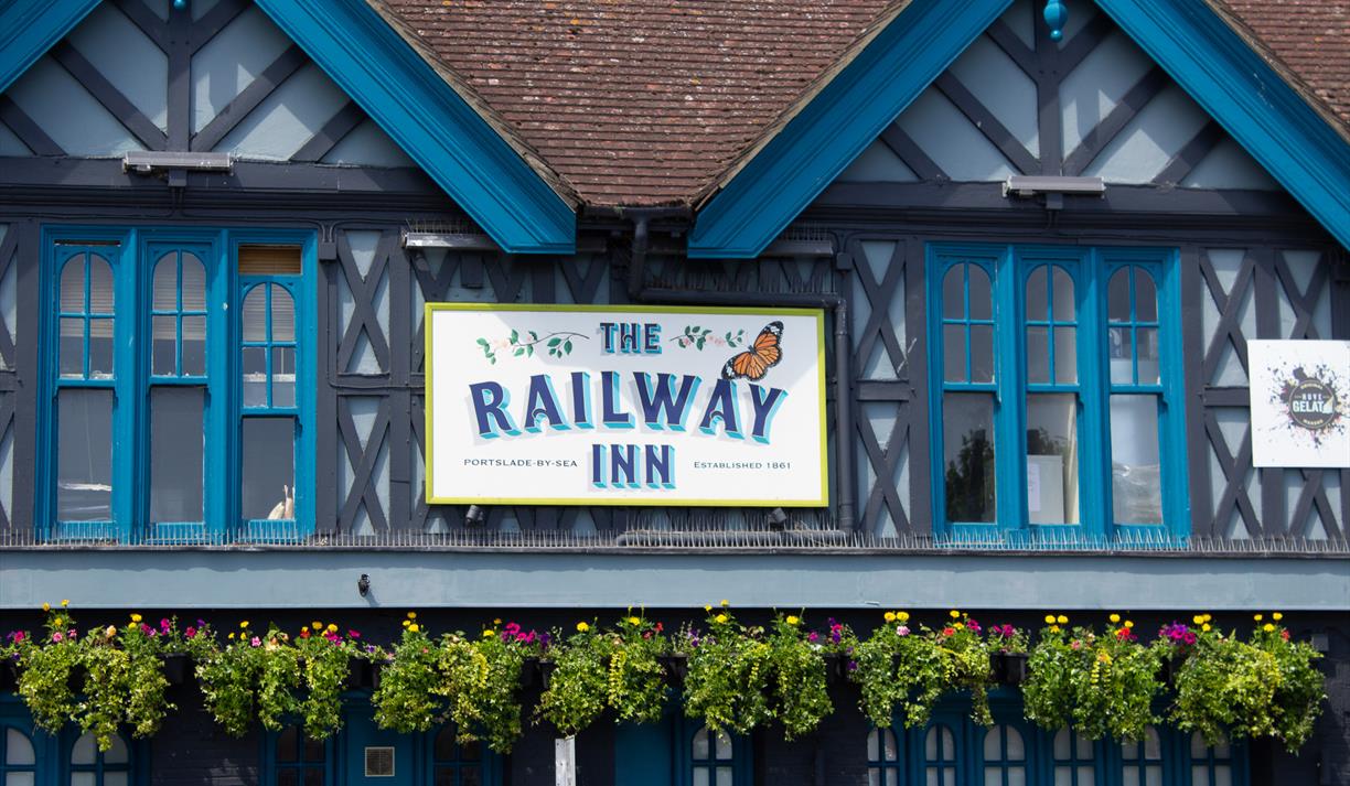 Close up of the sign on the outside of the Railway Inn pub