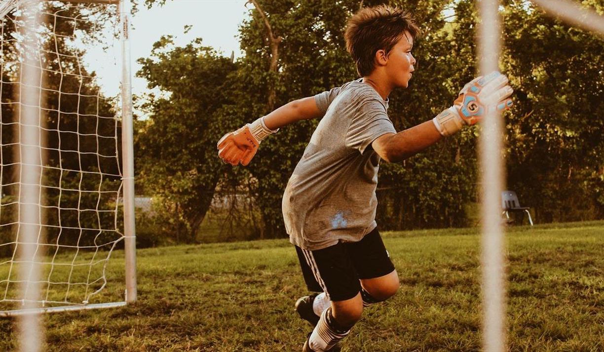 Boy playing football goalkeeper