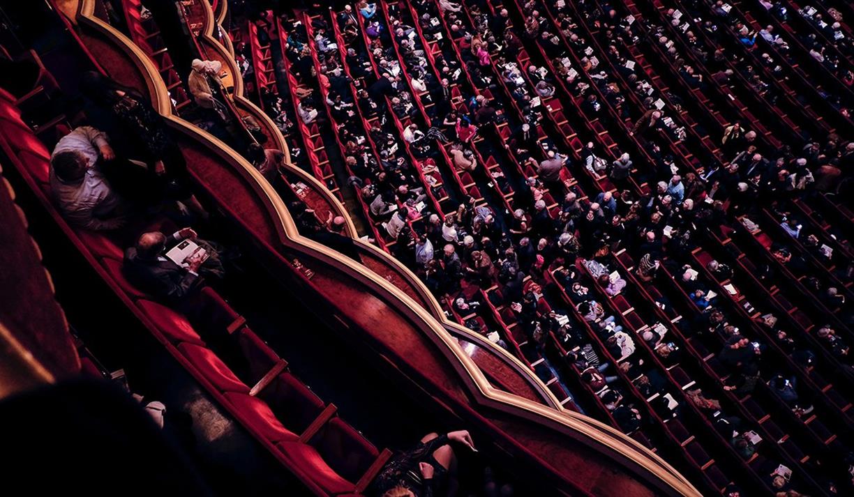 Audience sitting in a performance theatre