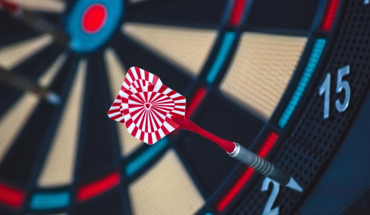 Red and white dart on dartboard