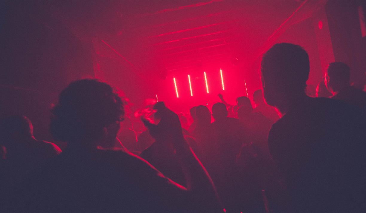 Dancing in red lit night club