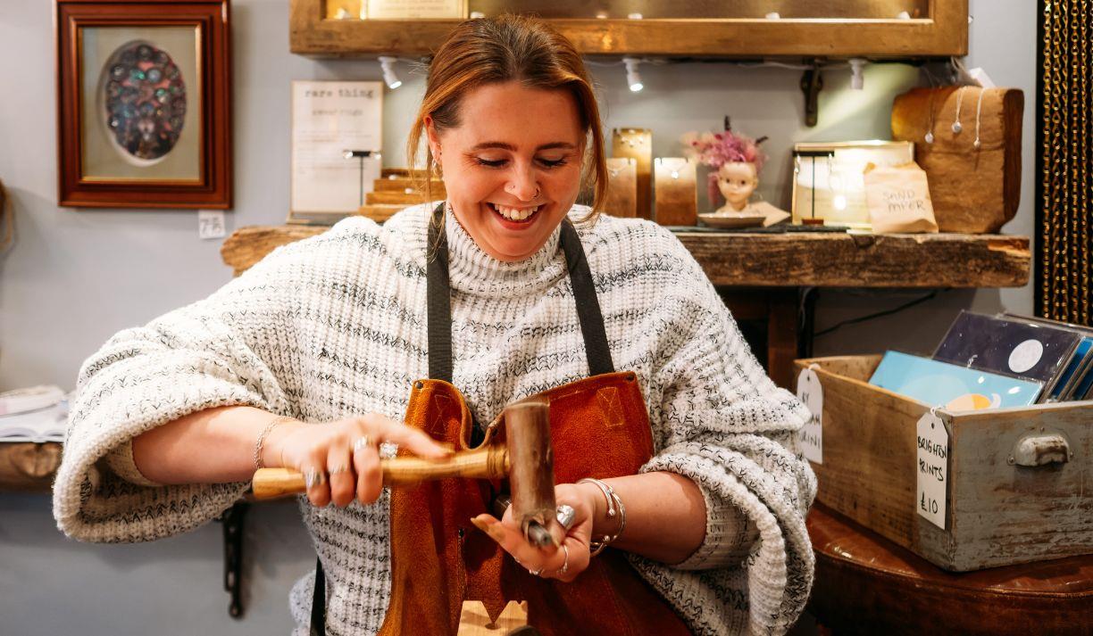 A lady enjoying a craft workshop.