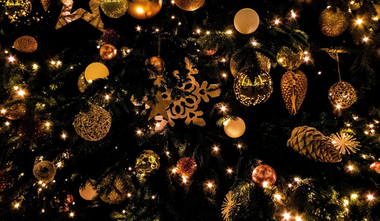 Christmas tree decorated with golden baubles and pinecones