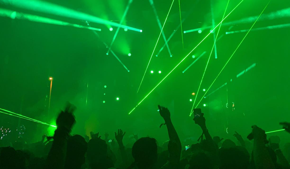 Green room with crowd and white strobe lights