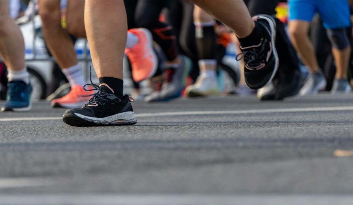 Dynamic photo of runner's feet and legs in trainers