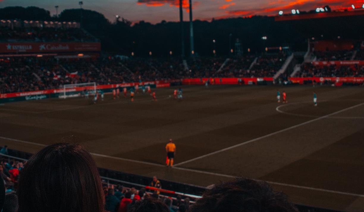 Football game at sunset in stadium