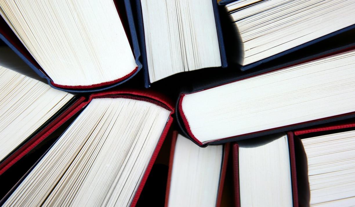 Nine book spines in a cluster from top