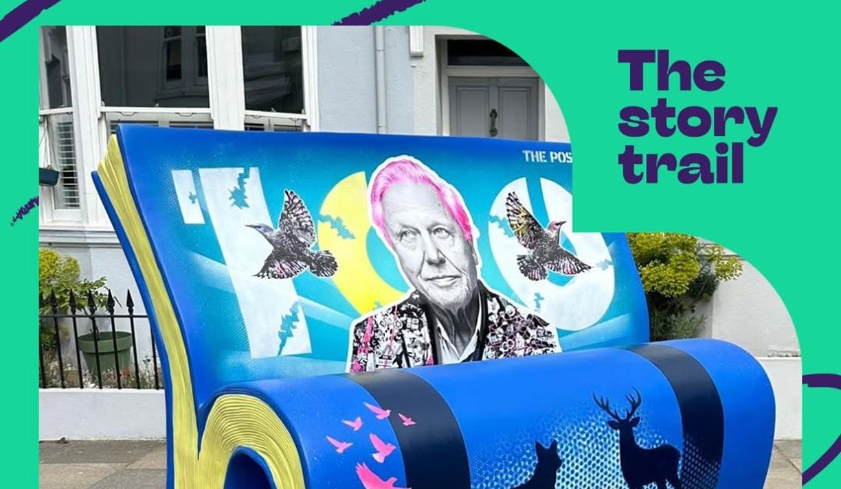 Photo of an art bench designed by The Postman featuring a picture of David Attenborough. The photo includes an overlay for The Story Trail.