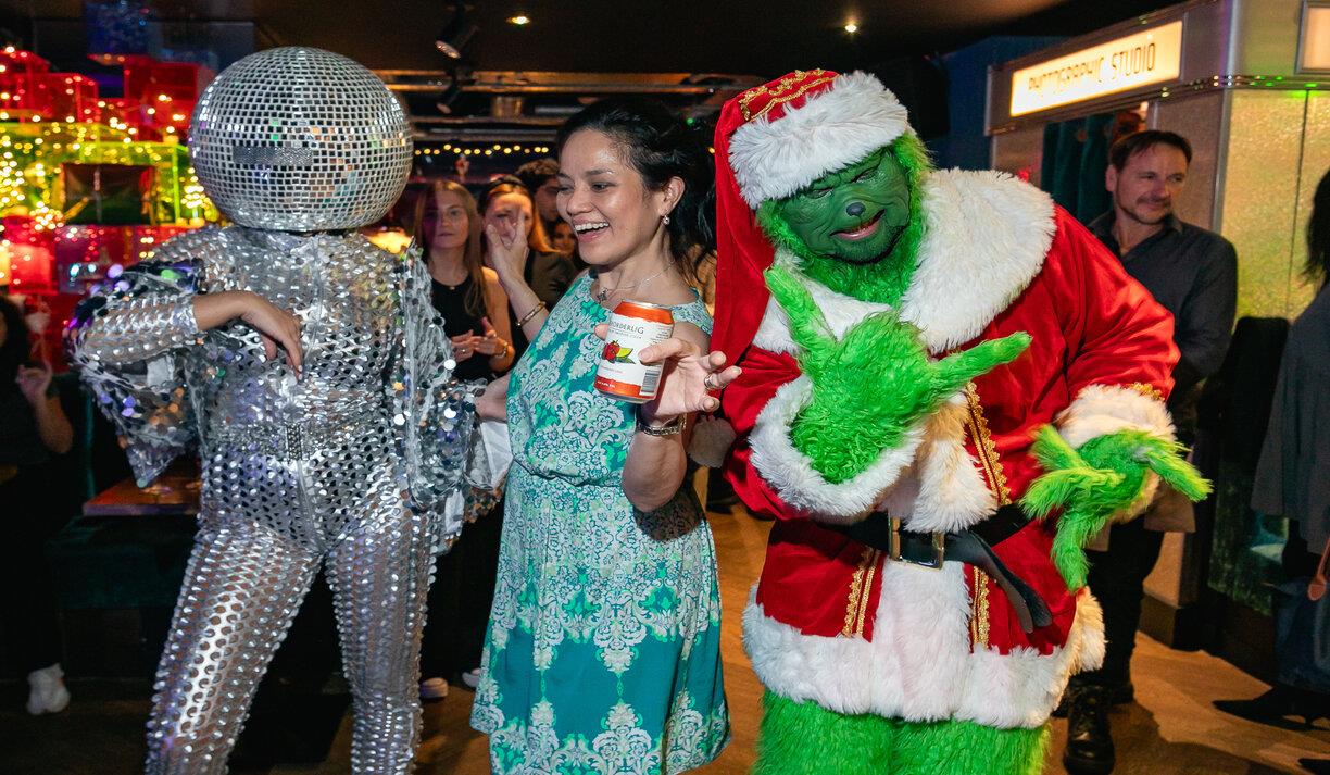 Party goers at Lucky Voice in Brighton dressed up in fancy dress outfits including the Grinch and a dancer wearing disco ball headwear.