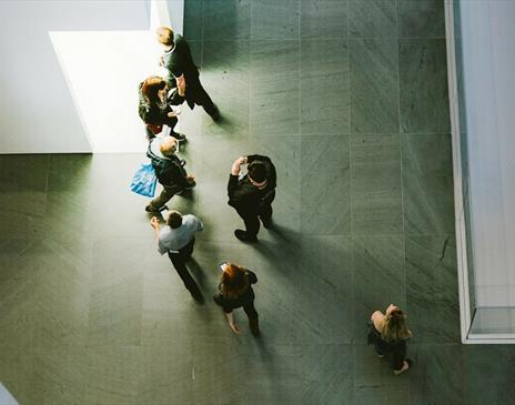 Top down view of people in grey space