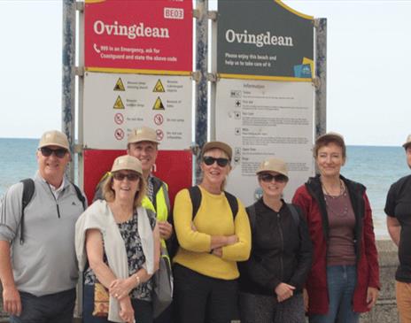 Walker in from of Ovingdean information board