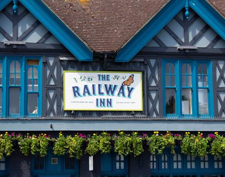 Close up of the sign on the outside of the Railway Inn pub