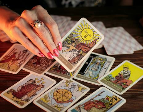 Hand holding colourful tarot cards
