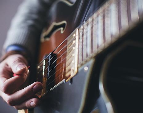 Person playing a guitar