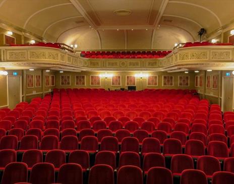 Empty red seats in a theatre