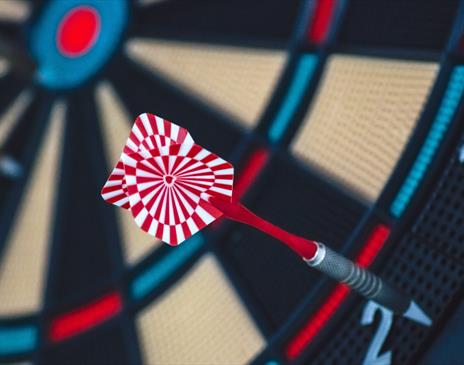 Red and white dart on dartboard