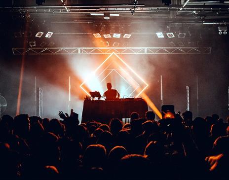 DJ performing in front of a crowd in a club