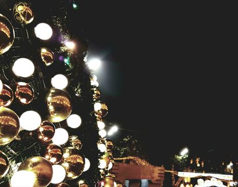 Gold and silver baubles displayed on the wall of an outdoor display