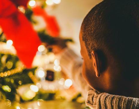 Small child close to Christmas tree