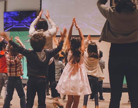 Kids participating in a theatre workshop