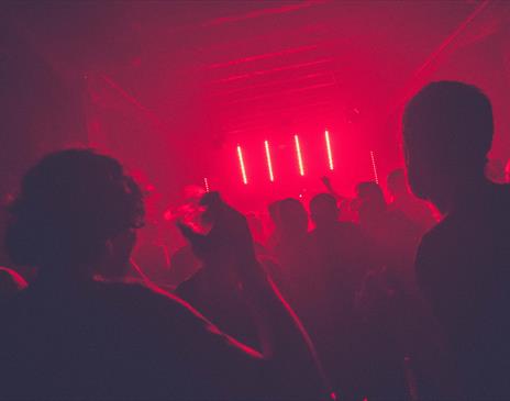 Dancing in red lit night club