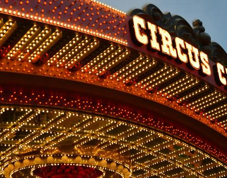 Circus roof sign surrounded by yellow and red lights