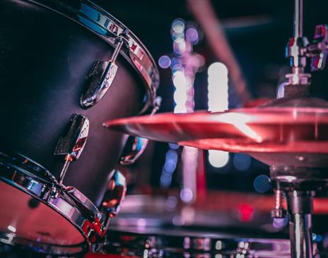 Black acoustic drum set with shiny hi hat