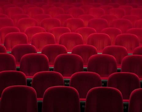 Empty red seats in a theatre