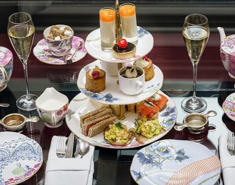 An afternoon tea with cakes and flowery pink tea set
