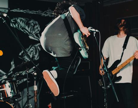 Guitarist jumping on stage