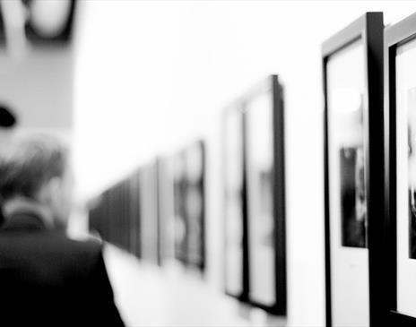 People looking at art on a wall