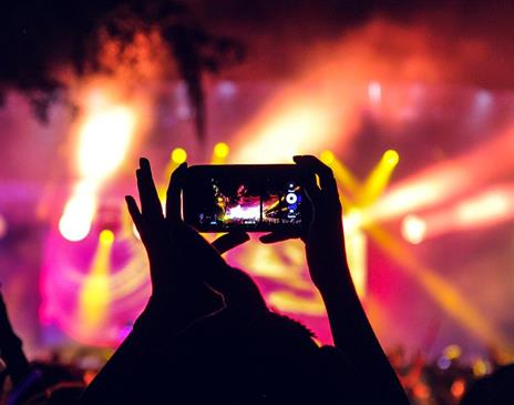 People at a concert taking pictures with phones